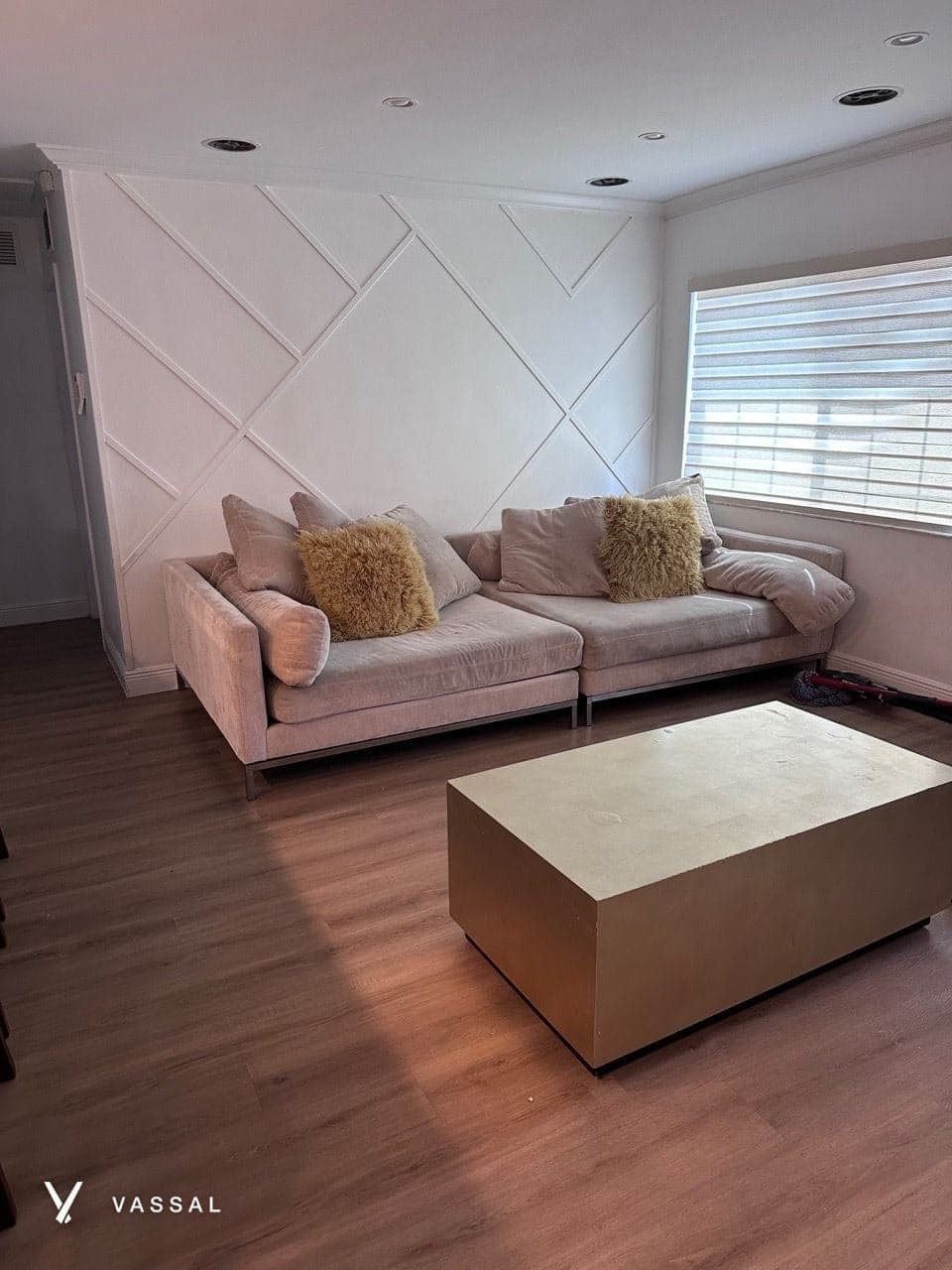 A tidy living room with a sofa and a coffee table on wood floors