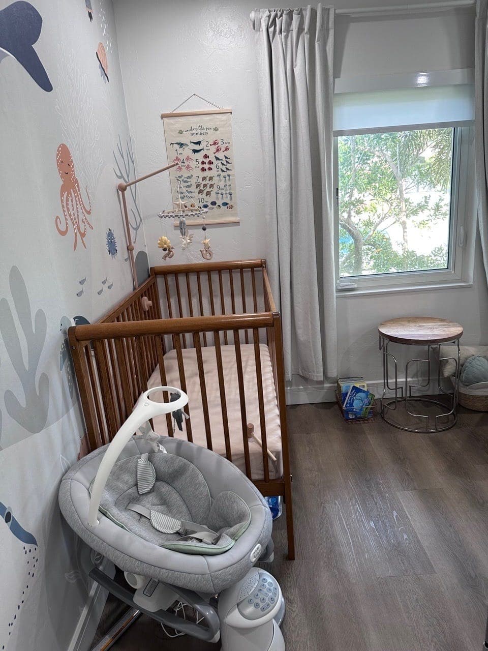 A tidy nursery with a wooden crib and a clear floor